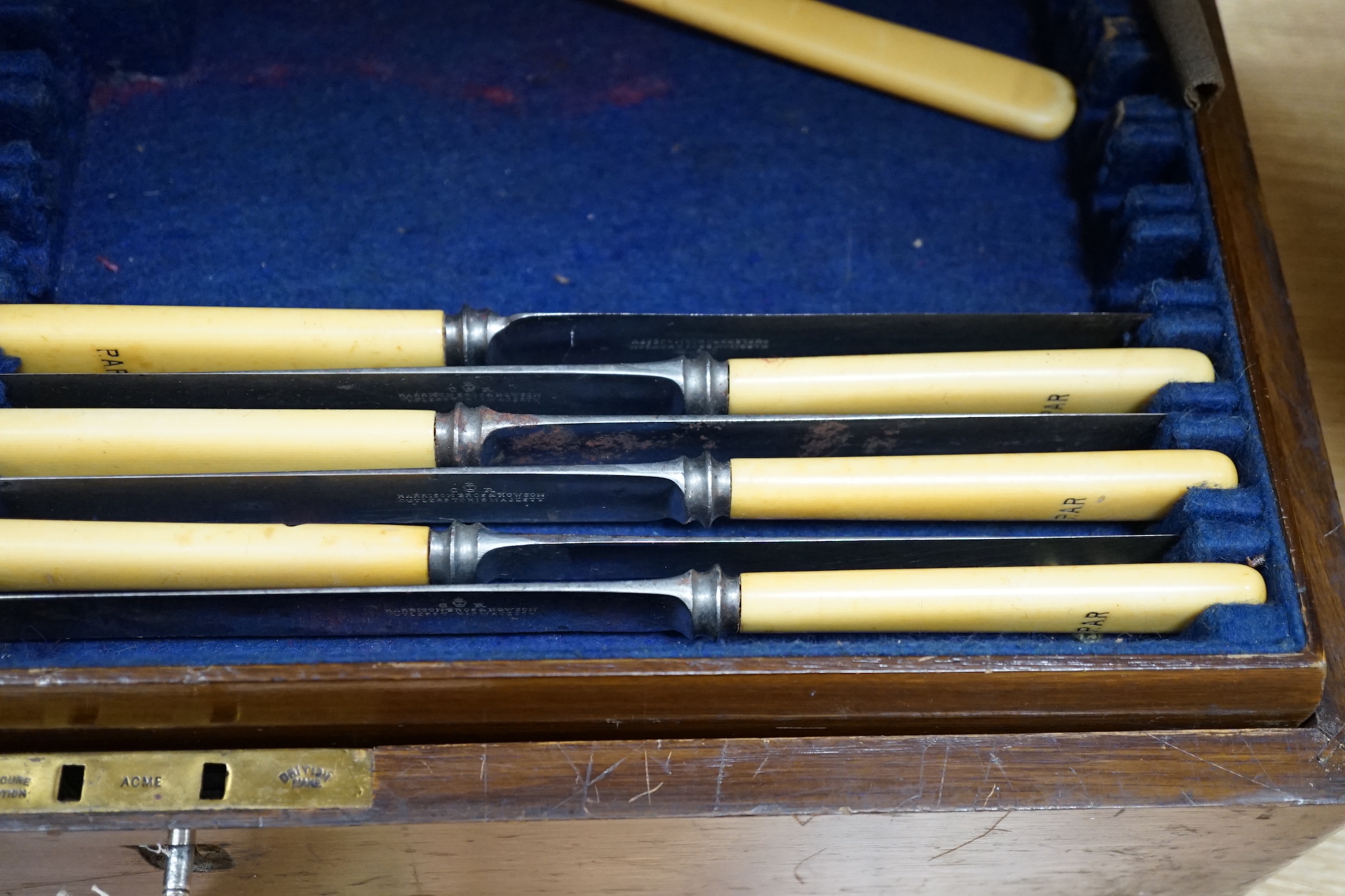 A 20th century oak cased canteen of cutlery, Harrison Bro’s & Howson, the knives with ivorine handles 47cm wide